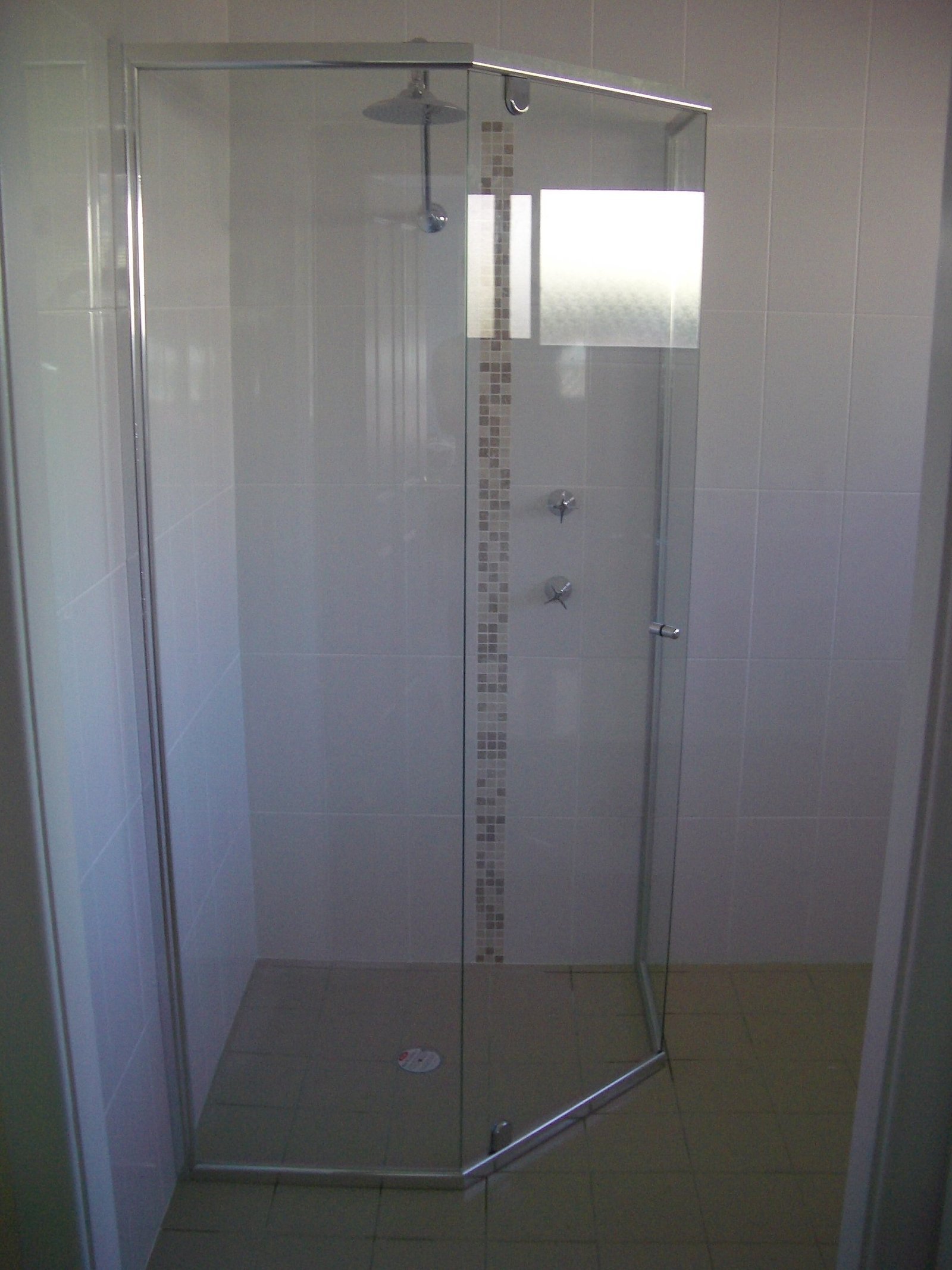 Frameless shower screen installation by Harbour Glass